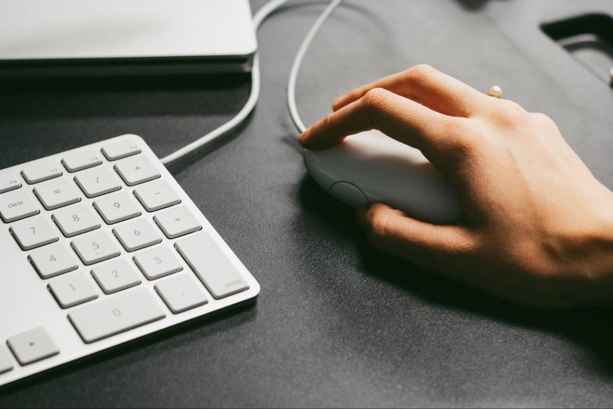 A person using a computer mouse, symbolising click fraud.